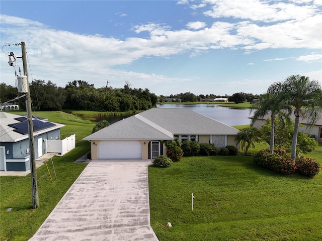 view of front of property featuring a garage, a front yard, and a water view