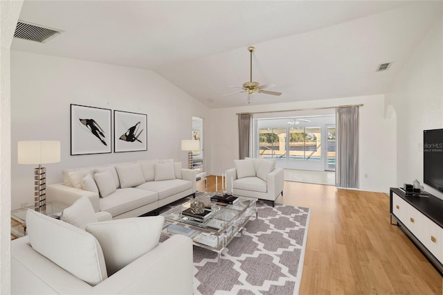 living room featuring ceiling fan, vaulted ceiling, and light hardwood / wood-style floors