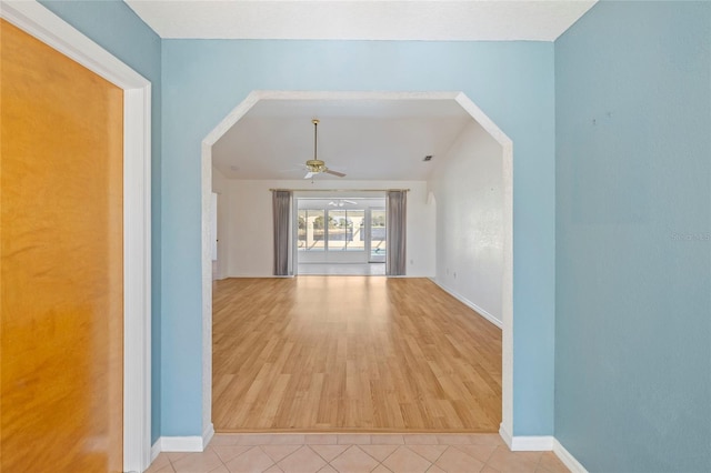 interior space with ceiling fan and light tile patterned floors