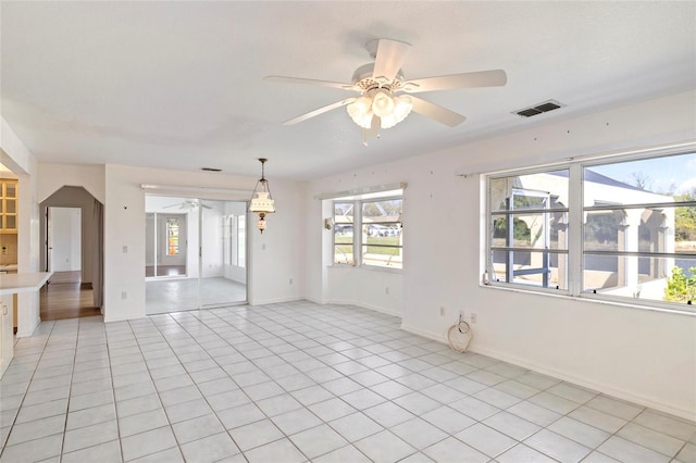 unfurnished room featuring ceiling fan and light tile patterned floors