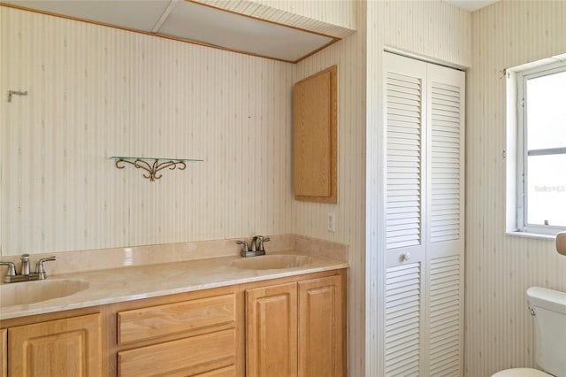 bathroom featuring toilet and vanity