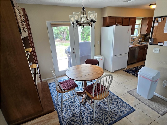 21427 Michigan Ave, Port Charlotte, FL 33952 - dining space with a chandelier, plenty of natural light, and light tile patterned floors