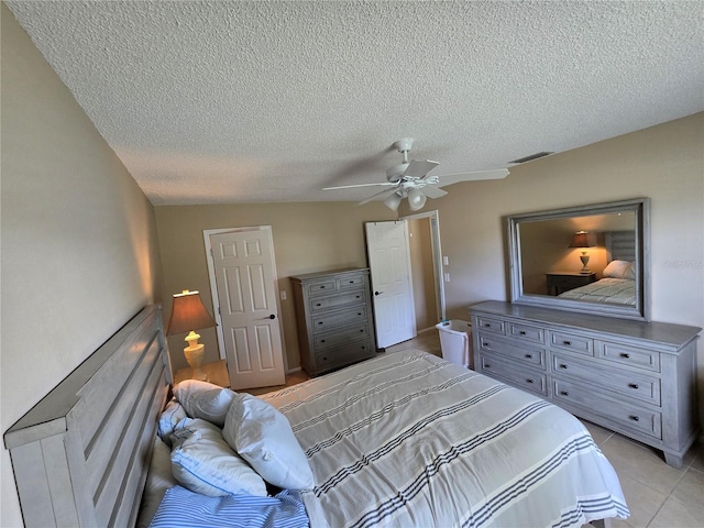 21427 Michigan Ave, Port Charlotte, FL 33952 - bedroom with a textured ceiling, light tile patterned floors, and a ceiling fan