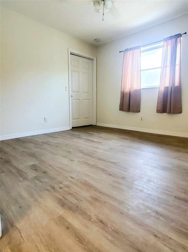 unfurnished room featuring wood-type flooring