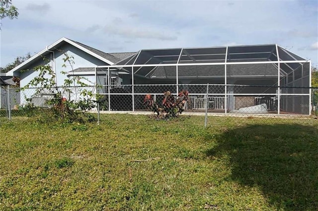 exterior space featuring a lawn and glass enclosure