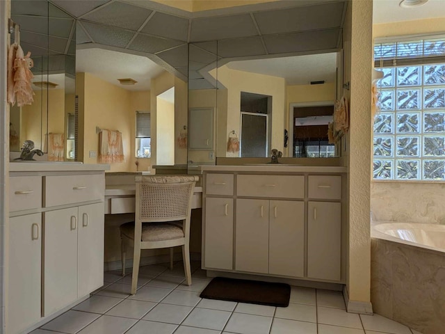 bathroom with vanity, tile patterned flooring, and a bathing tub