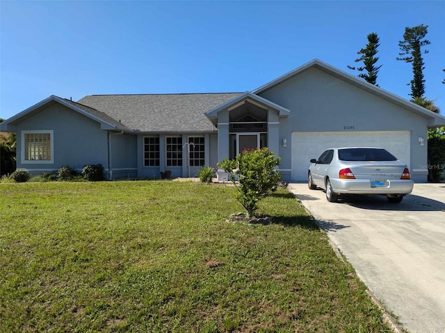 ranch-style house featuring a garage and a front lawn