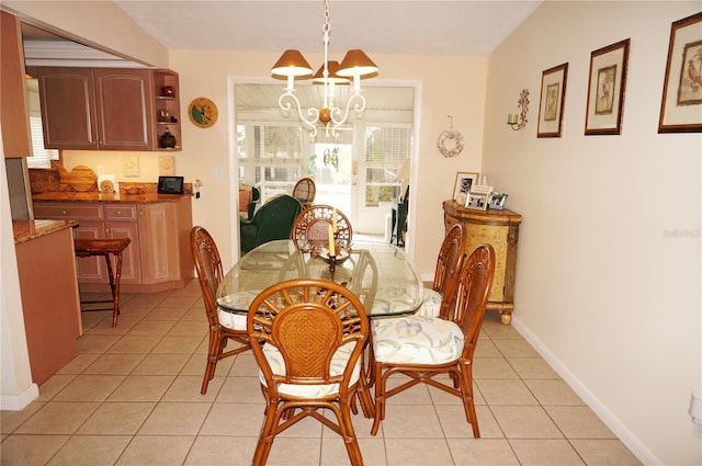 dining room with an inviting chandelier and light tile floors