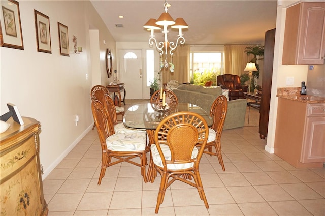 dining room featuring an inviting chandelier and light tile floors