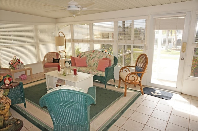 sunroom / solarium featuring a healthy amount of sunlight and ceiling fan