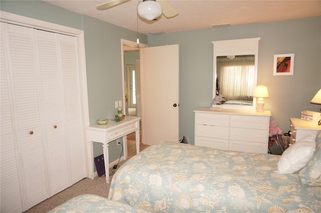 bedroom featuring a closet, light colored carpet, and ceiling fan