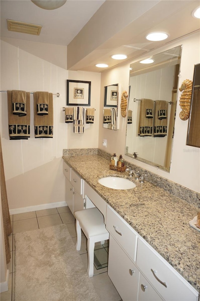 bathroom with vanity and tile flooring