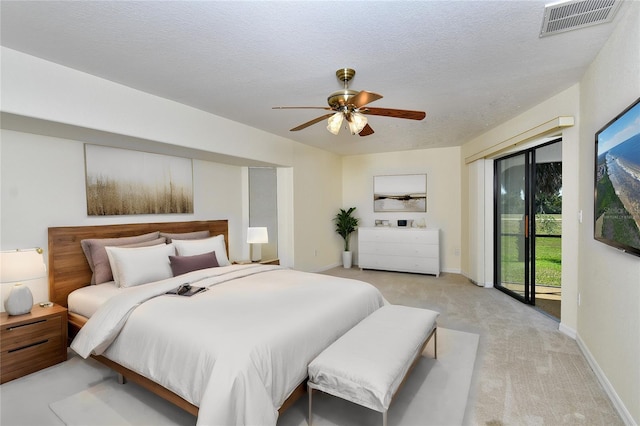 bedroom with light carpet, a textured ceiling, ceiling fan, and access to exterior