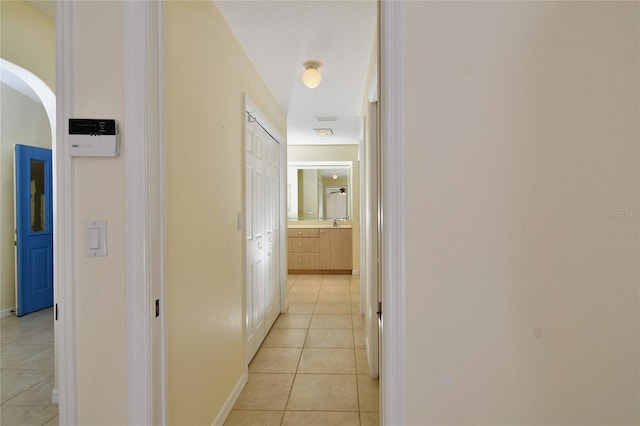 hallway featuring light tile floors