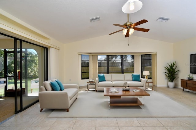 living room with plenty of natural light, vaulted ceiling, ceiling fan, and light tile floors