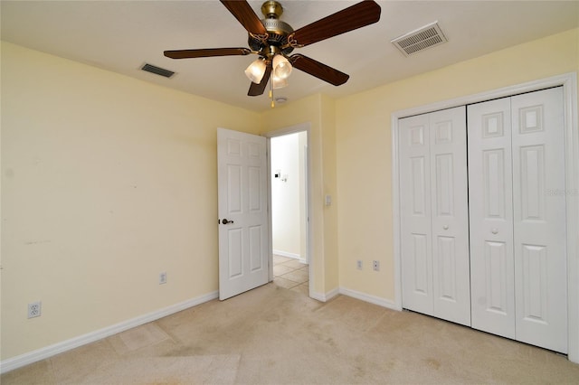 unfurnished bedroom with light carpet, a closet, and ceiling fan