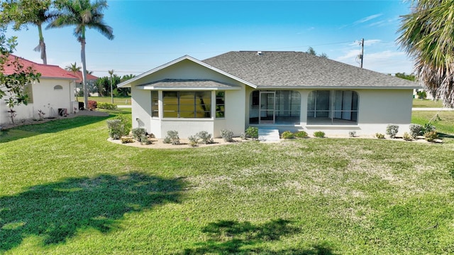 rear view of house with a lawn