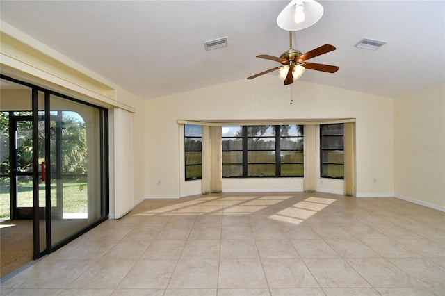 tiled empty room featuring plenty of natural light, ceiling fan, and vaulted ceiling