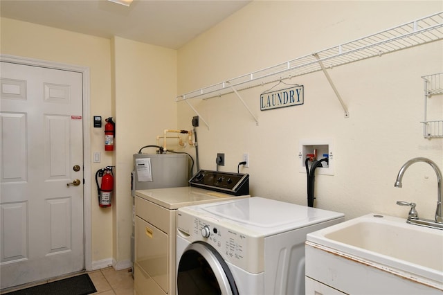 washroom with sink, light tile floors, electric dryer hookup, washer hookup, and independent washer and dryer