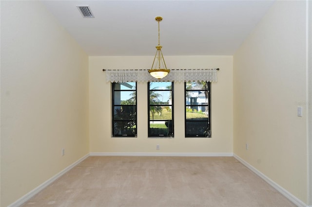 empty room with light colored carpet