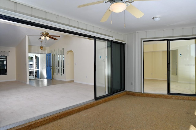 carpeted empty room featuring ceiling fan