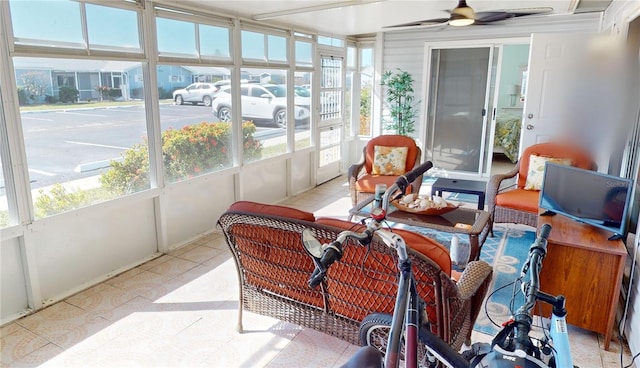 sunroom / solarium with a healthy amount of sunlight and ceiling fan