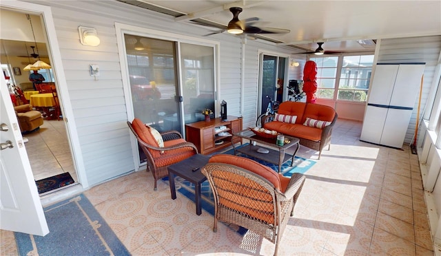 sunroom / solarium featuring ceiling fan