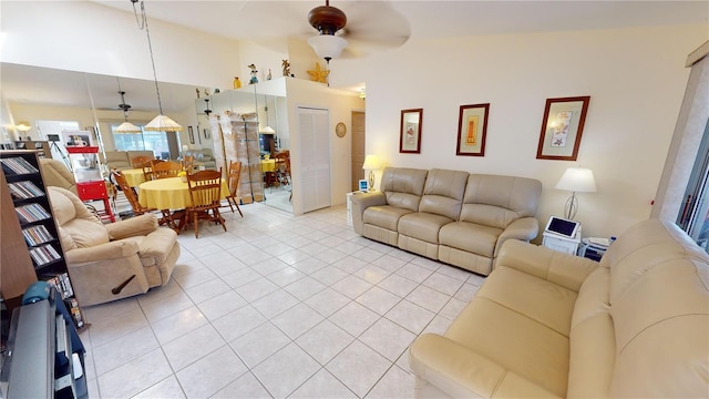 tiled living room featuring high vaulted ceiling and ceiling fan