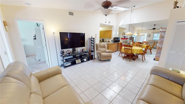 tiled living room with ceiling fan