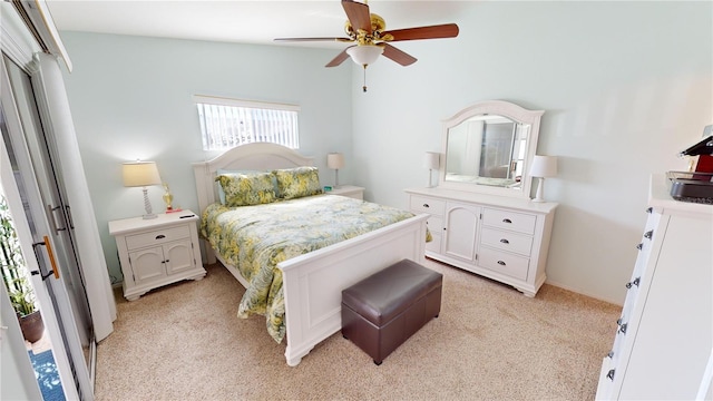 bedroom with ceiling fan, vaulted ceiling, and light colored carpet