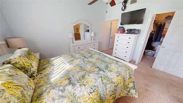 bedroom featuring a closet, light carpet, a spacious closet, and ceiling fan