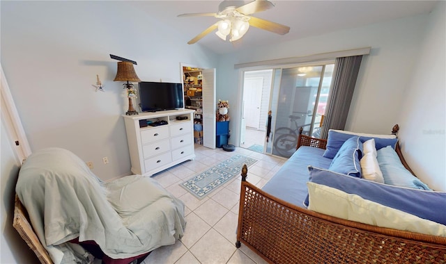 tiled bedroom with a walk in closet, access to exterior, a closet, and ceiling fan