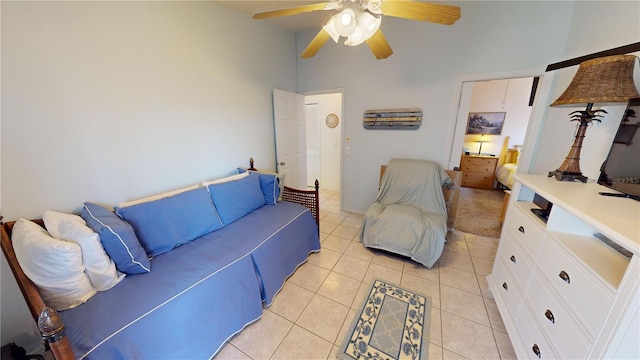 bedroom featuring light tile flooring, a high ceiling, and ceiling fan