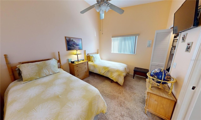 bedroom featuring a high ceiling, light carpet, and ceiling fan