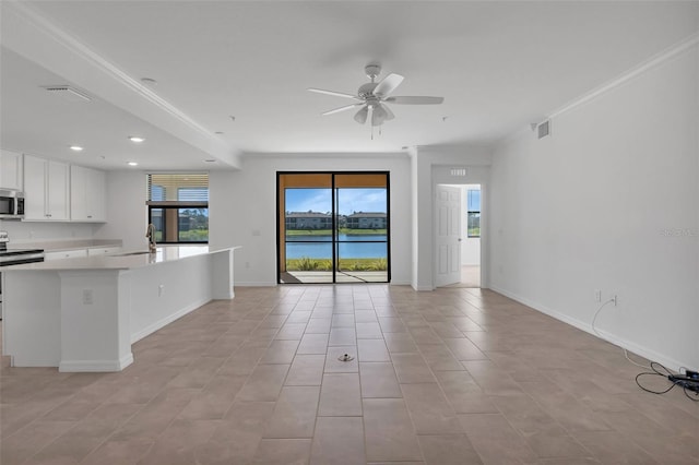 interior space featuring sink, crown molding, ceiling fan, and a water view