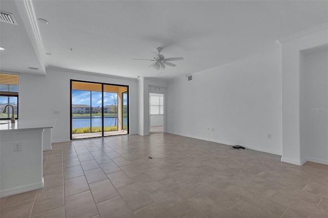 unfurnished room with light tile patterned flooring, sink, a water view, crown molding, and ceiling fan