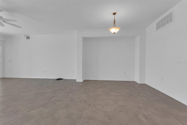 spare room featuring crown molding and ceiling fan