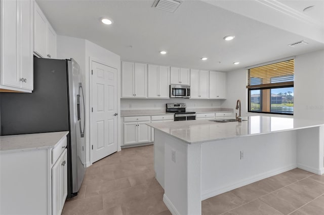 kitchen with sink, a center island with sink, white cabinets, and appliances with stainless steel finishes