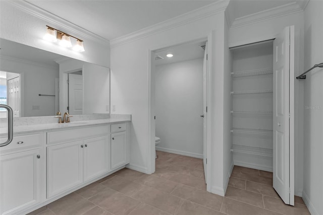 bathroom featuring vanity, tile patterned floors, ornamental molding, and toilet