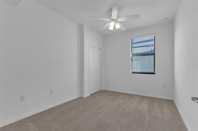 carpeted empty room with ceiling fan