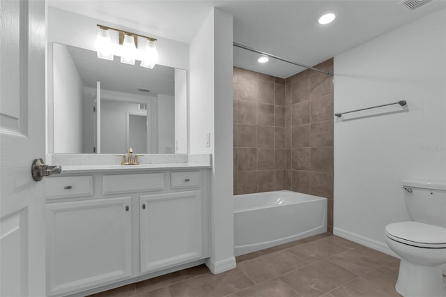 full bathroom with tile patterned floors, vanity, toilet, and tiled shower / bath combo