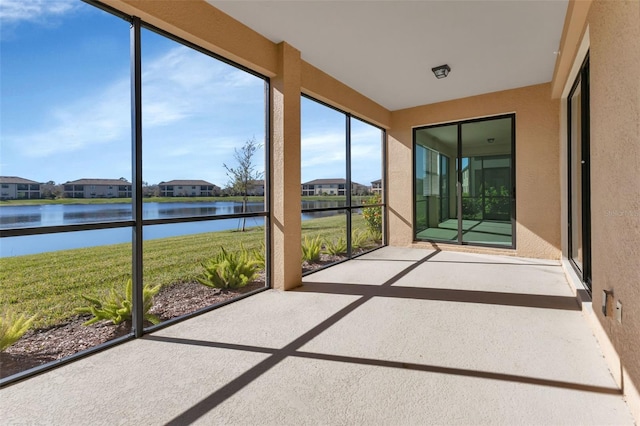 unfurnished sunroom with a water view