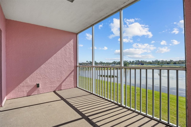 unfurnished sunroom featuring a water view