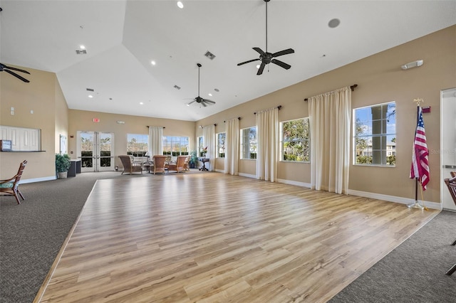 interior space featuring high vaulted ceiling, ceiling fan, and light wood-type flooring