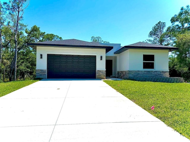 view of front of property with a front lawn and a garage