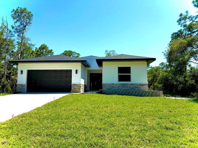 view of front of property with a front lawn and a garage