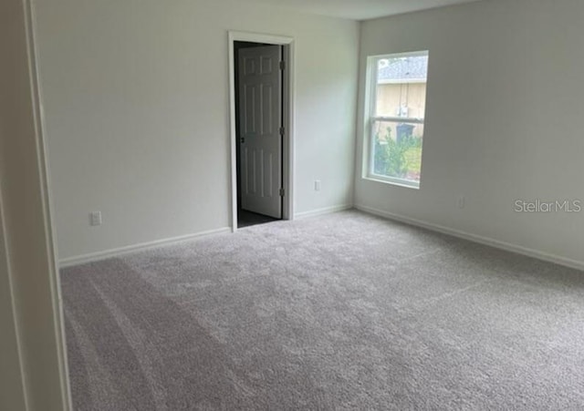 carpeted empty room with a healthy amount of sunlight