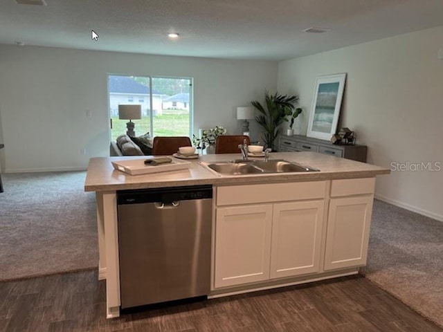 kitchen with white cabinetry, dishwasher, sink, a kitchen island with sink, and dark carpet