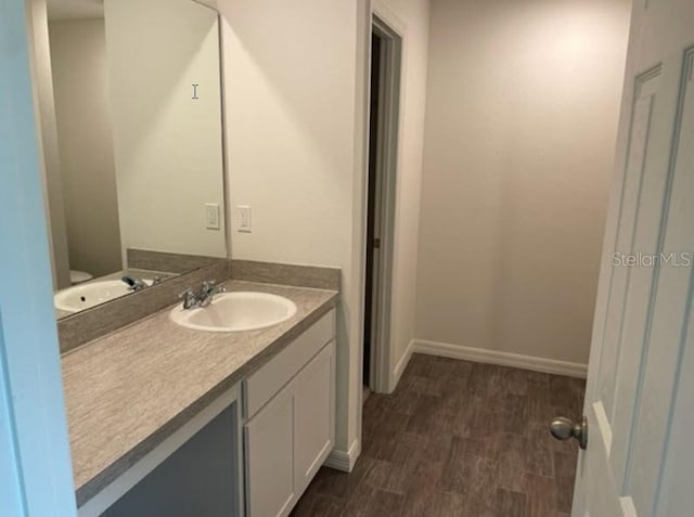 bathroom with hardwood / wood-style flooring and vanity