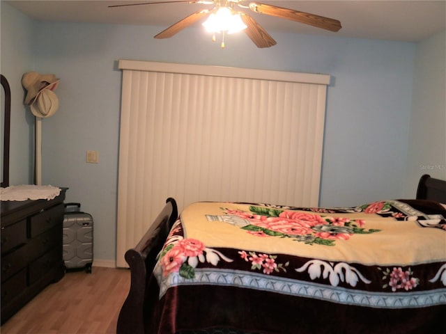 bedroom with ceiling fan and light hardwood / wood-style flooring